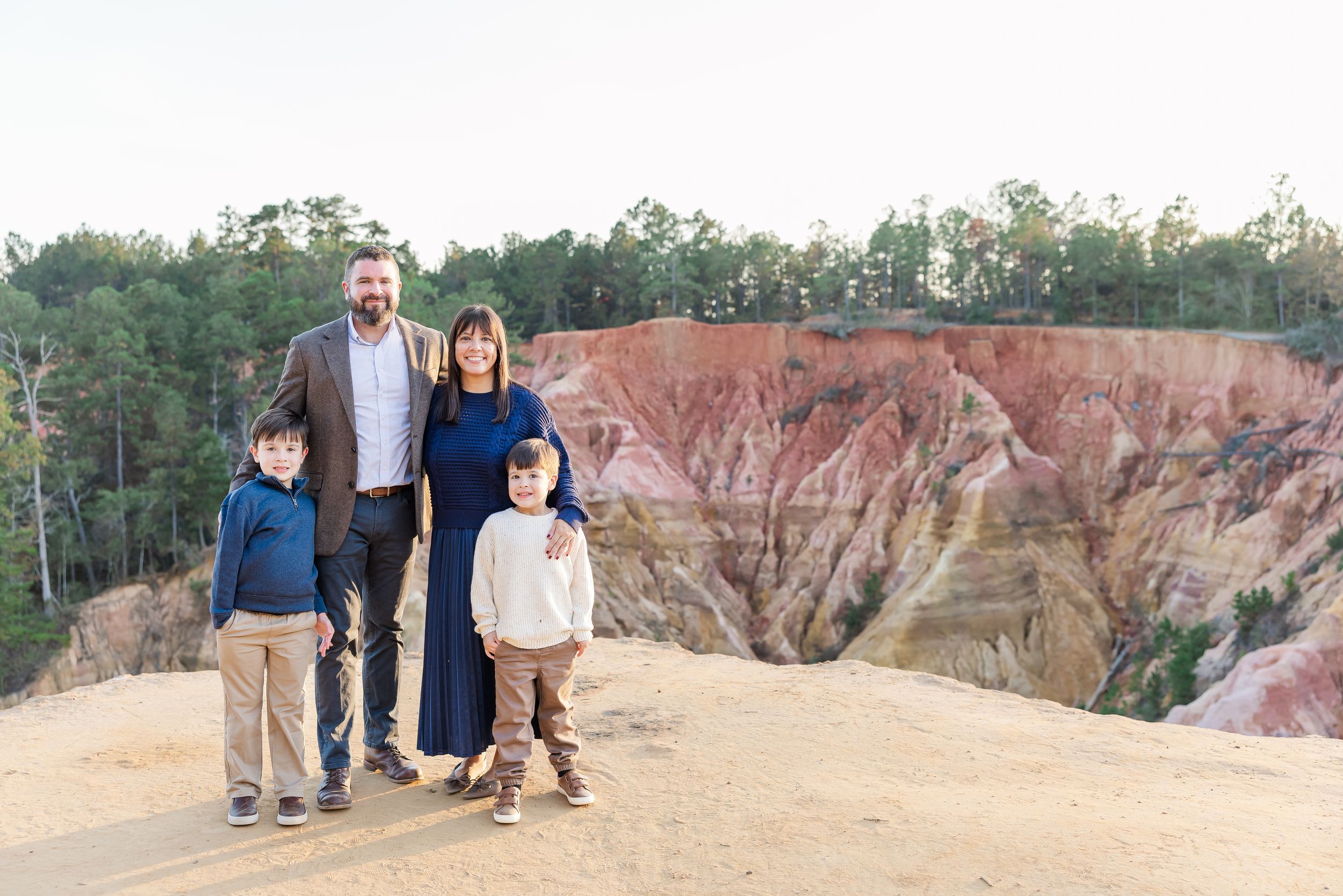People explore the colorful Providence Canyon State Park in Georgia with its vibrant red clay formations and hiking trails.