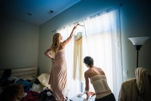 A bride and bridesmaid getting ready