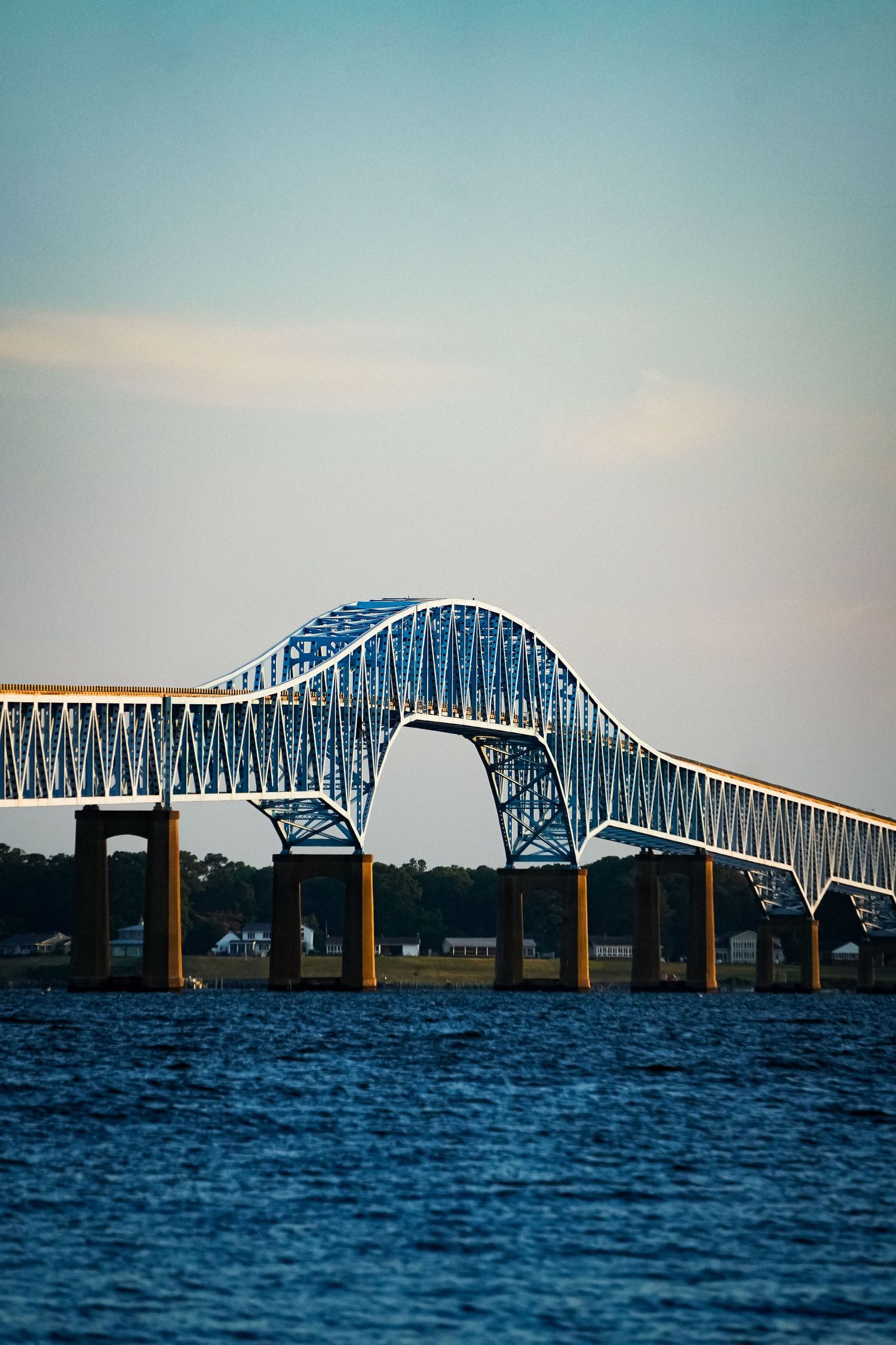 The Francis Scott Key Bridge arches dramatically over the Patapsco River with its distinctive blue steel design.