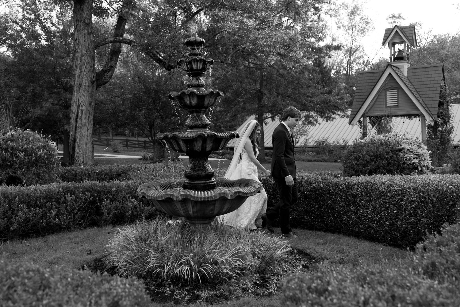 A series of black and white photos showing a romantic garden wedding ceremony with classic outdoor decor and scenery.