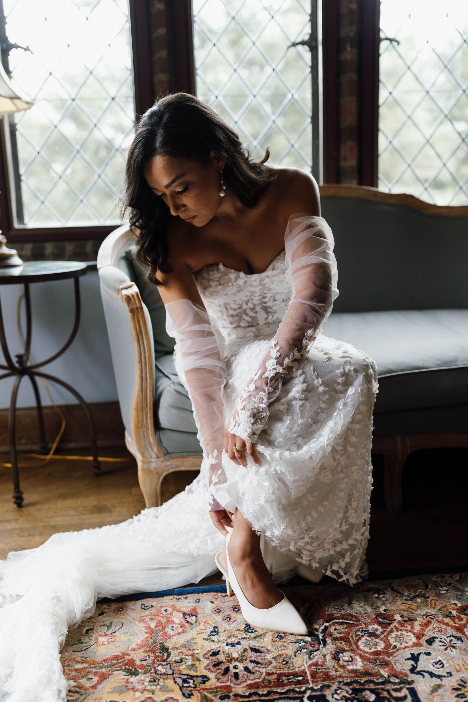 Close-up shots of a white lace wedding dress against a patterned carpet.