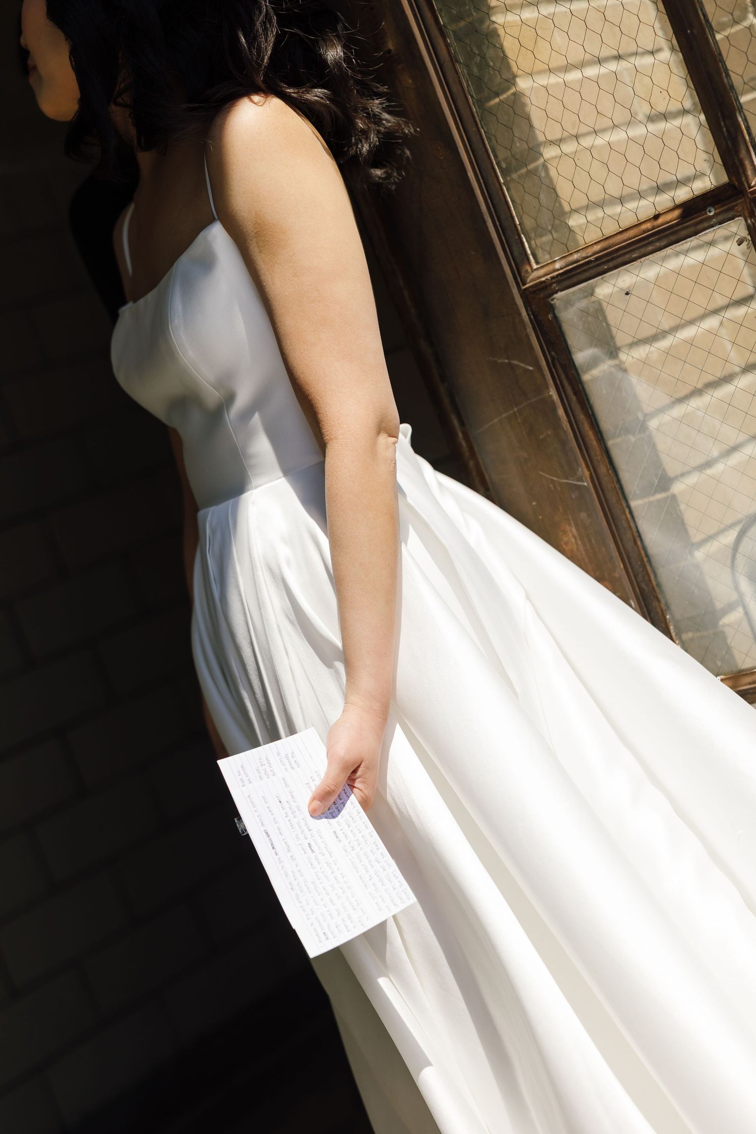 Series of photos showing the movement of a flowing white wedding dress against a dark background.