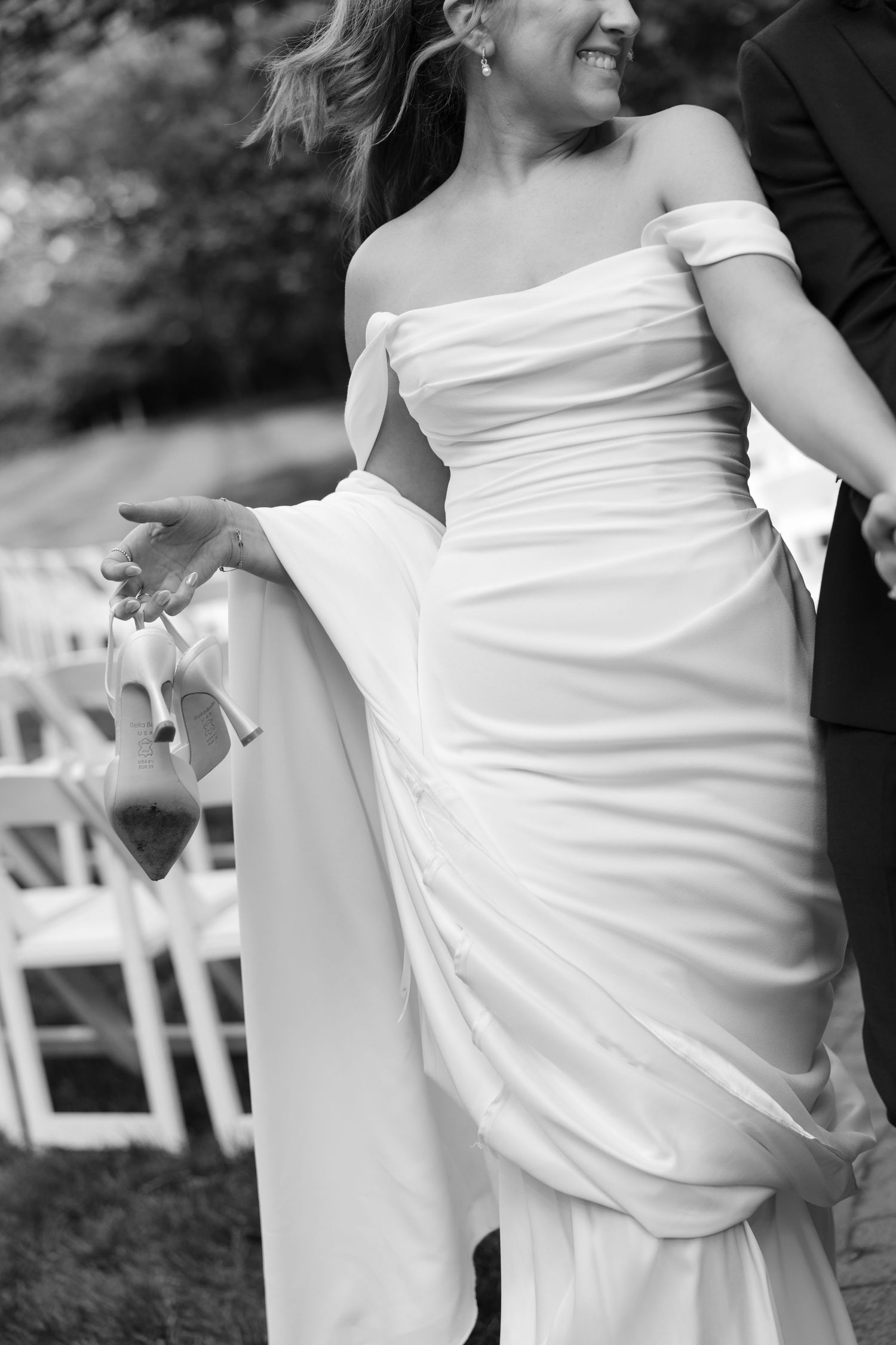 Series of black and white photos showing details of a white wedding dress in motion.
