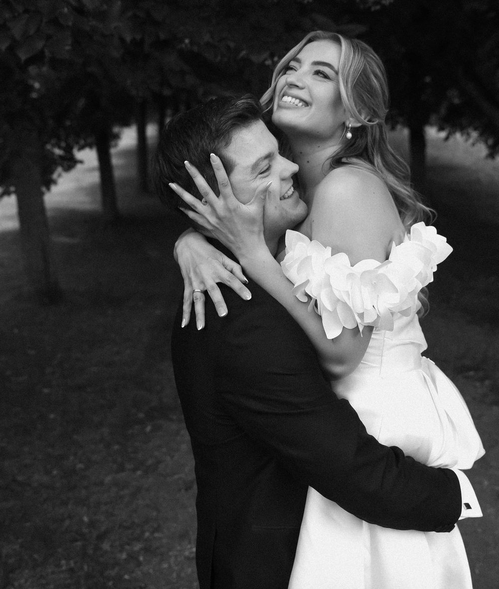 A black and white romantic wedding photo series showing a couple embracing and dancing together outdoors.