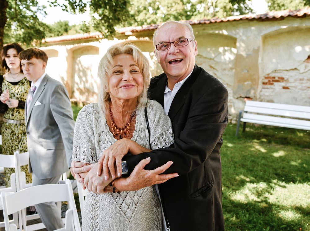 A collage of outdoor wedding celebration photos showing couples embracing and dancing at a sunny garden venue.