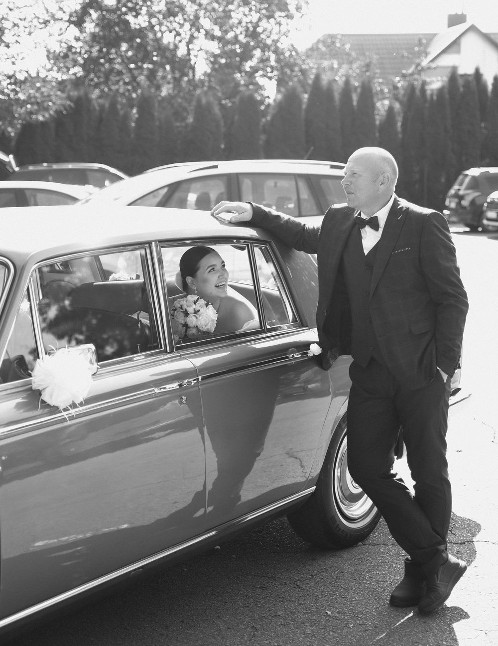 A black and white wedding photo sequence showing a classic car with people getting in and out during a formal occasion.