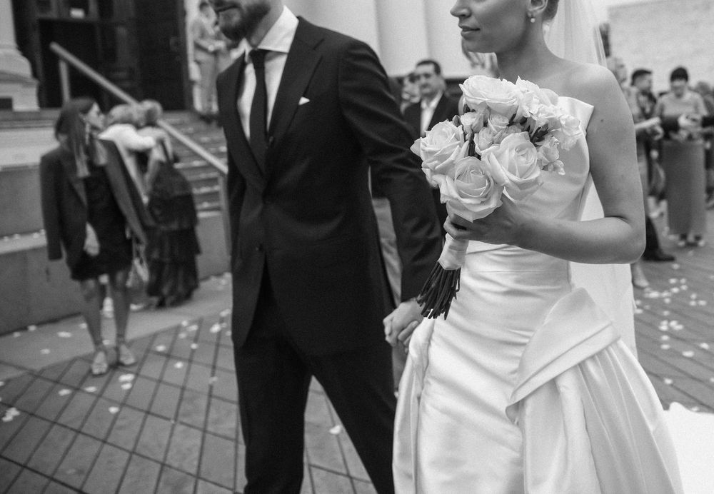 A black and white collage of wedding moments showing formal attire, dancing, and celebrations at an elegant venue.