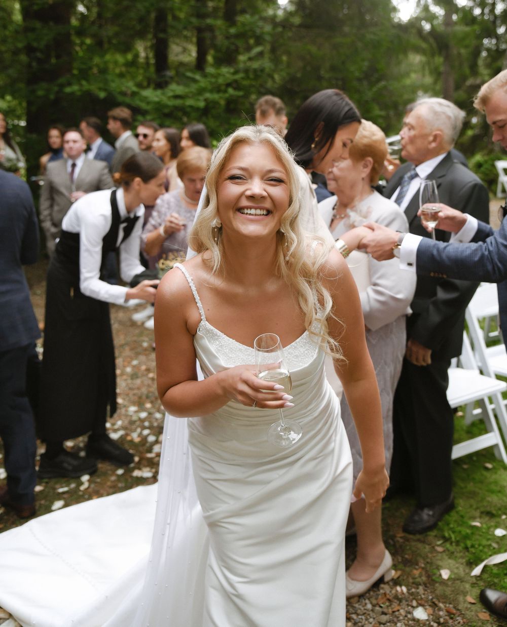 A series of candid wedding reception photos showing joyful dancing and celebration in an outdoor garden setting.