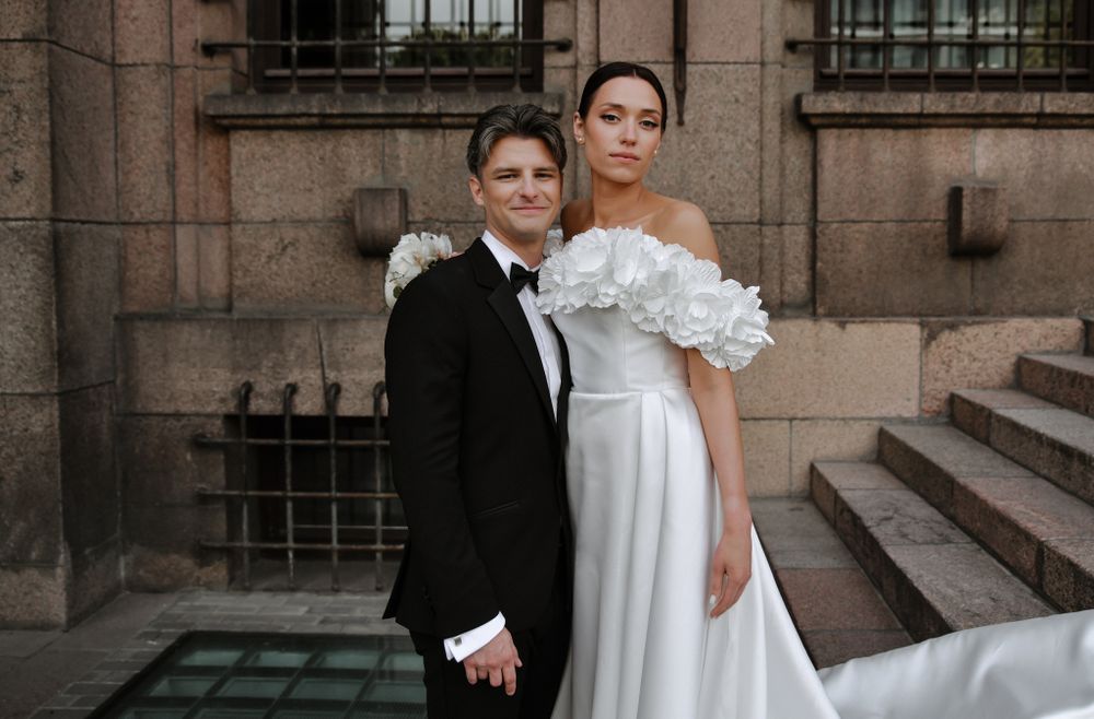 Modern wedding portrait on stone steps with architectural details.