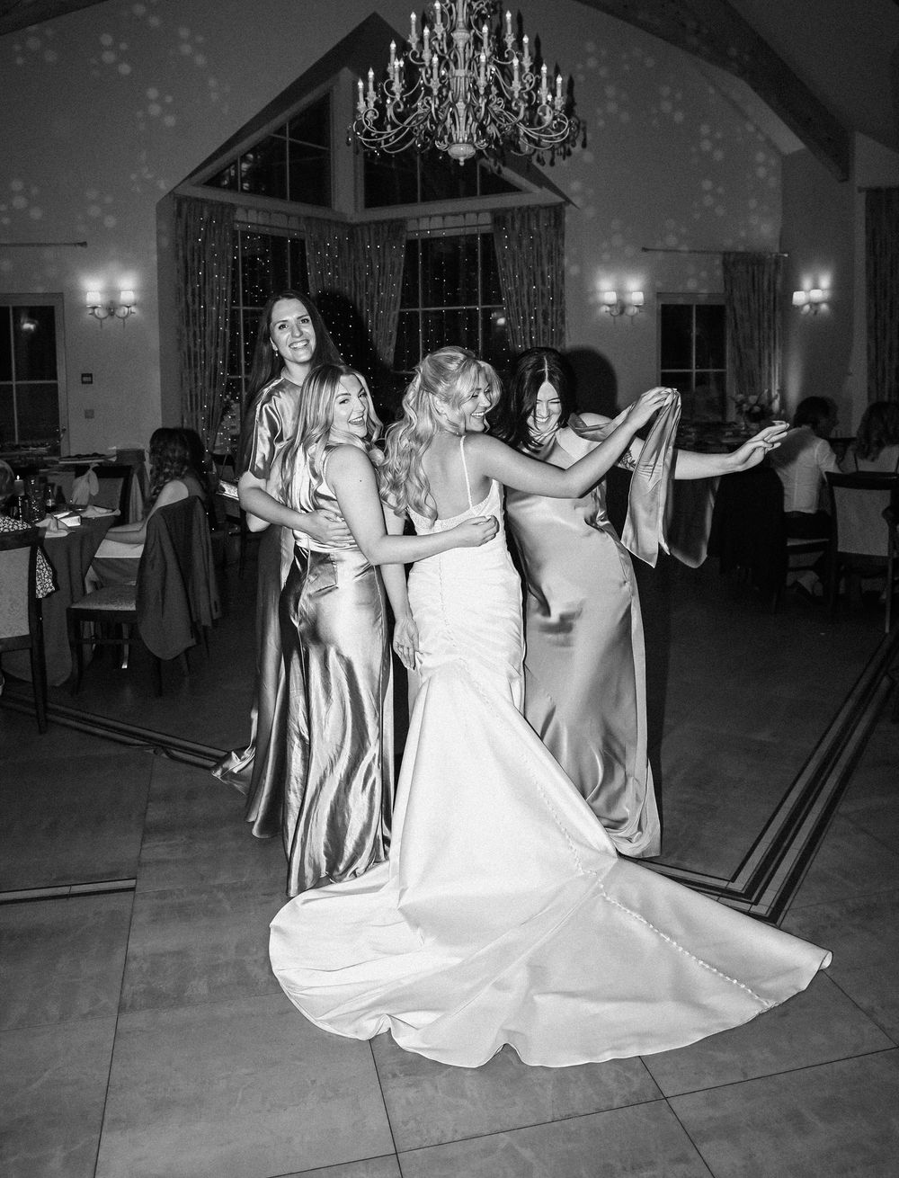 Black and white wedding dance sequence showing the bride's flowing white dress twirling across the dance floor.
