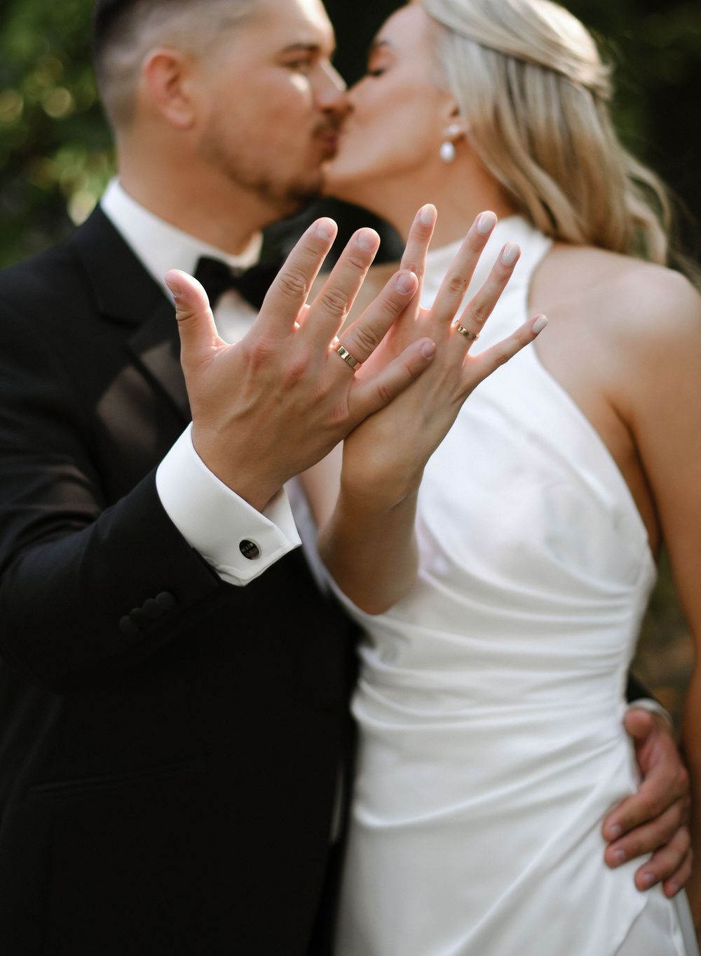 A romantic wedding photo sequence showing a couple in white and black formalwear sharing tender kisses outdoors.