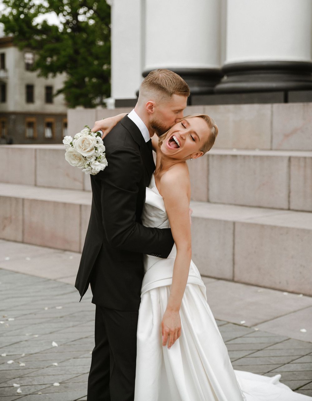 A romantic wedding photo sequence captured outdoors showing tender moments between newlyweds on stone steps.