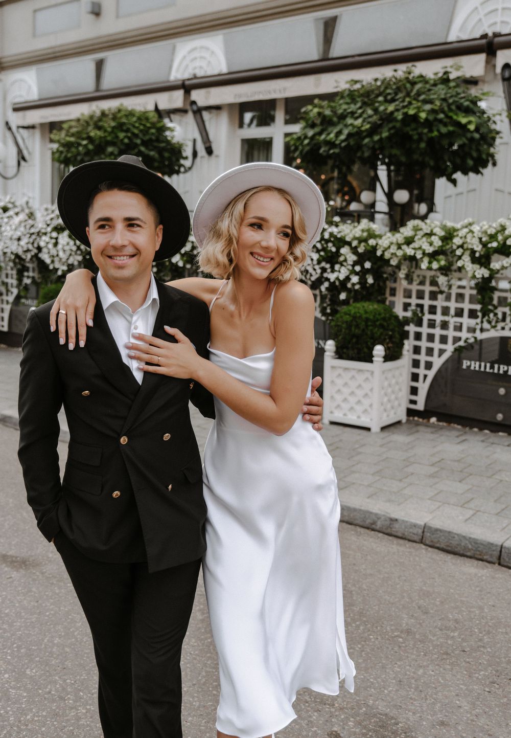 Outdoor wedding photos showing couple in white dress and black suit against garden backdrop.