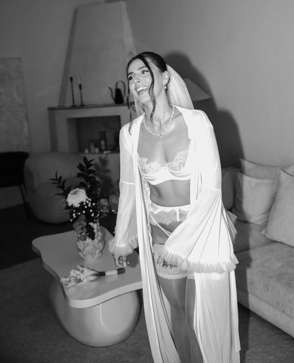 A person in white loungewear poses in different relaxed positions against a light interior setting.