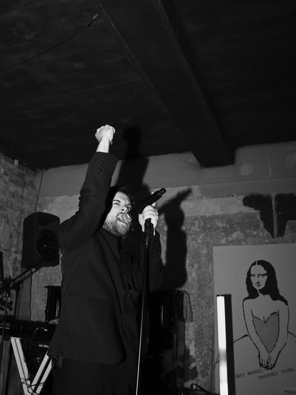 A series of black and white photographs showing silhouettes and figures in dark, moody lighting against stark backgrounds.