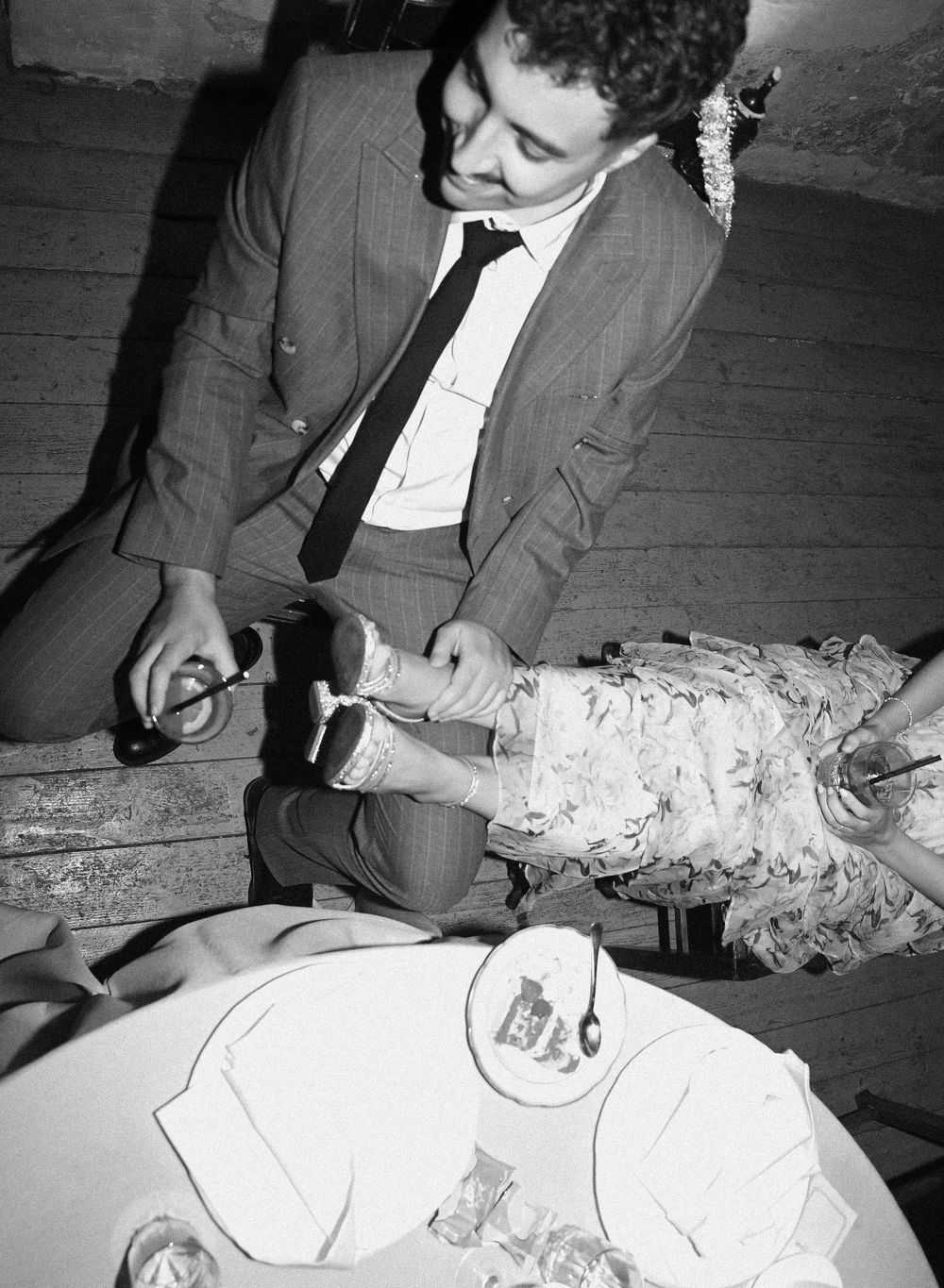 Vintage black and white photo series showing someone signing documents at a desk with papers spread out.