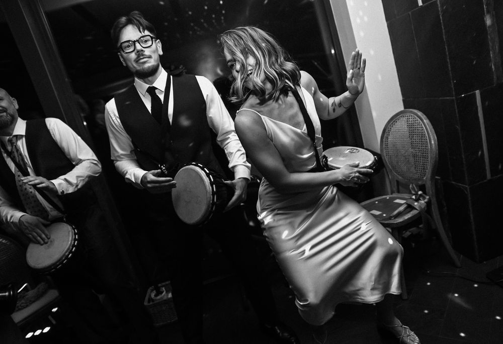 Black and white photos show musicians performing with banjos and other instruments in a lively setting.