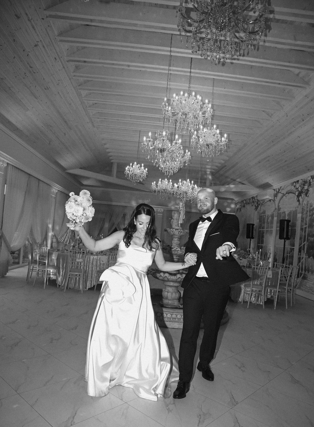 Black and white photos show a couple dancing in an elegant ballroom with crystal chandeliers and ornate decor.