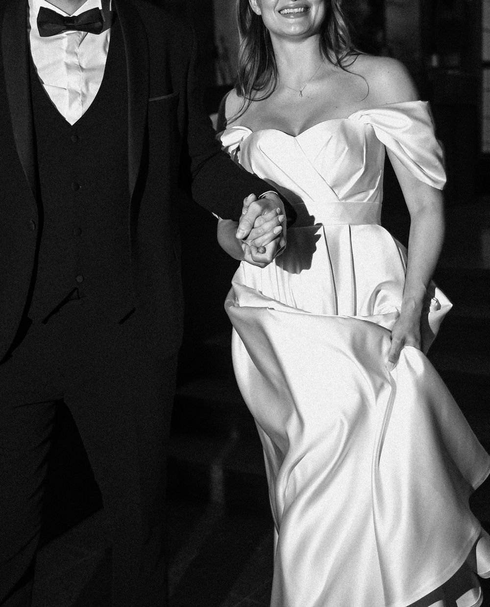 A black and white photo sequence showing a person in a white dress dancing and twirling with joyful movement.