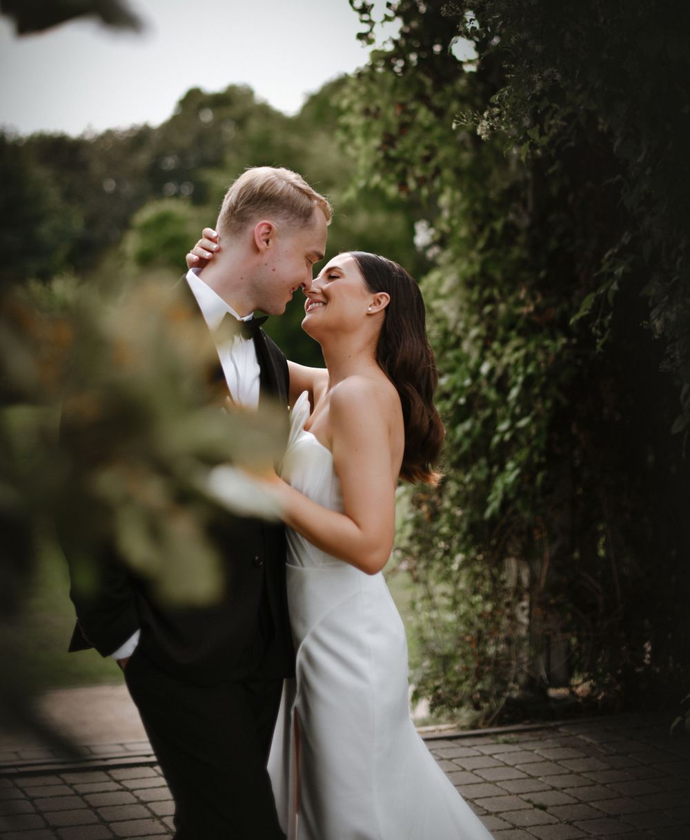 Intimate wedding portraits captured in natural outdoor garden setting.