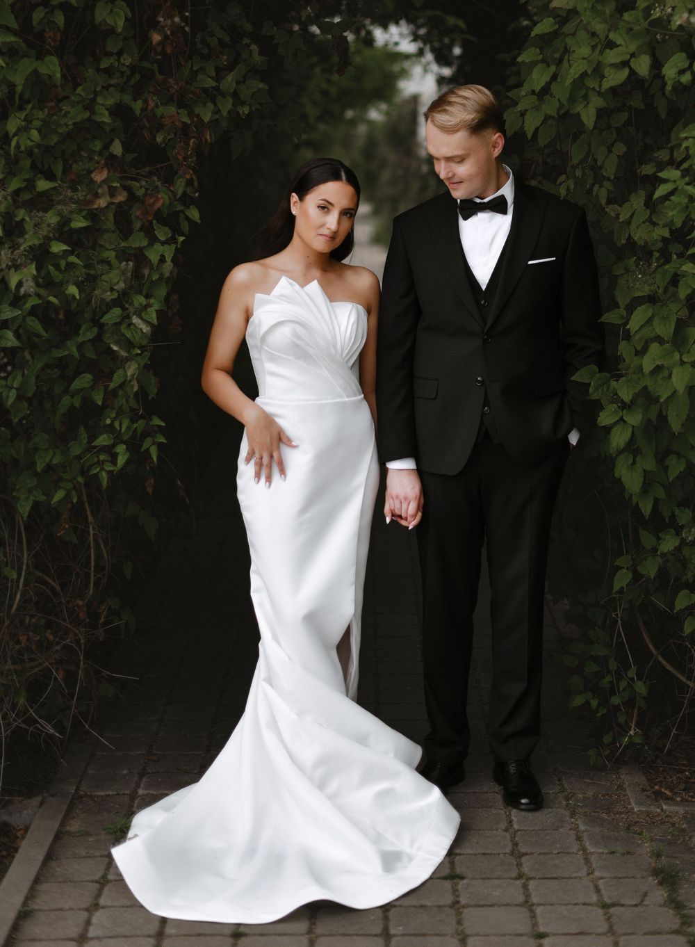 Artistic wedding photos showing couple in formal attire against garden backdrop.