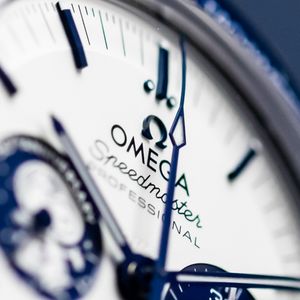 Extreme close-up of an Omega Speedmaster Professional watch face. Luxury product photography.
