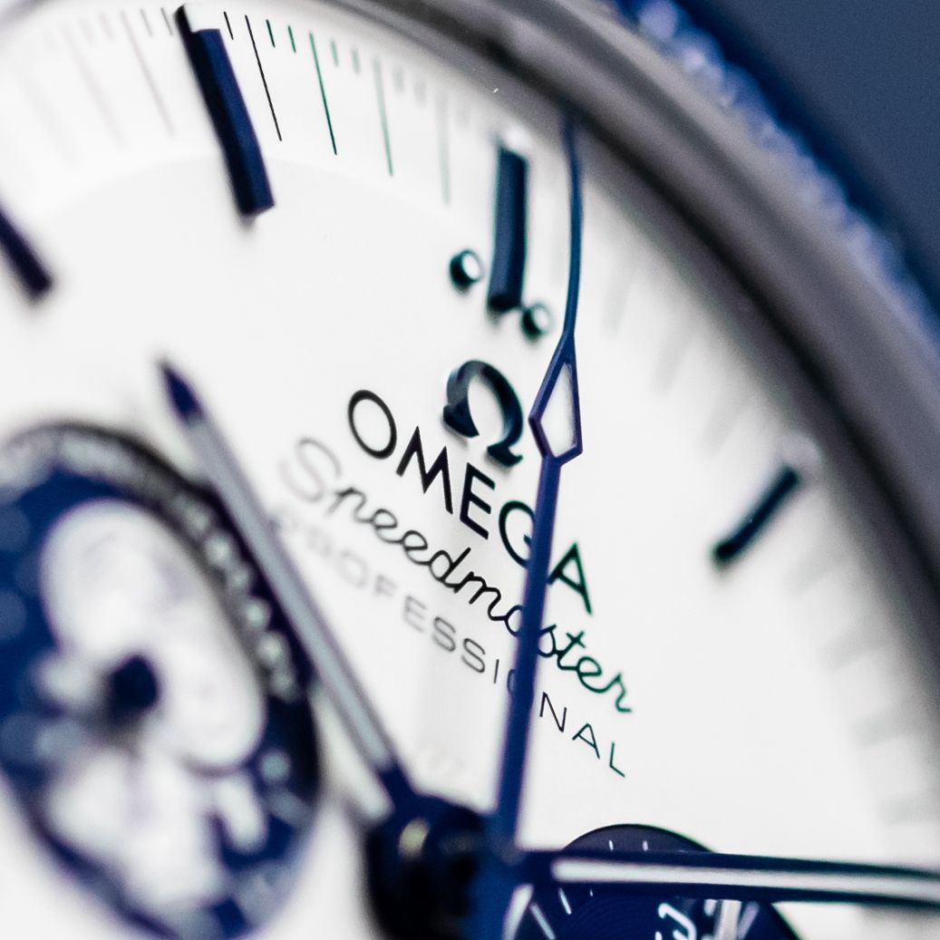 Extreme close-up of an Omega Speedmaster Professional watch face. Luxury product photography.