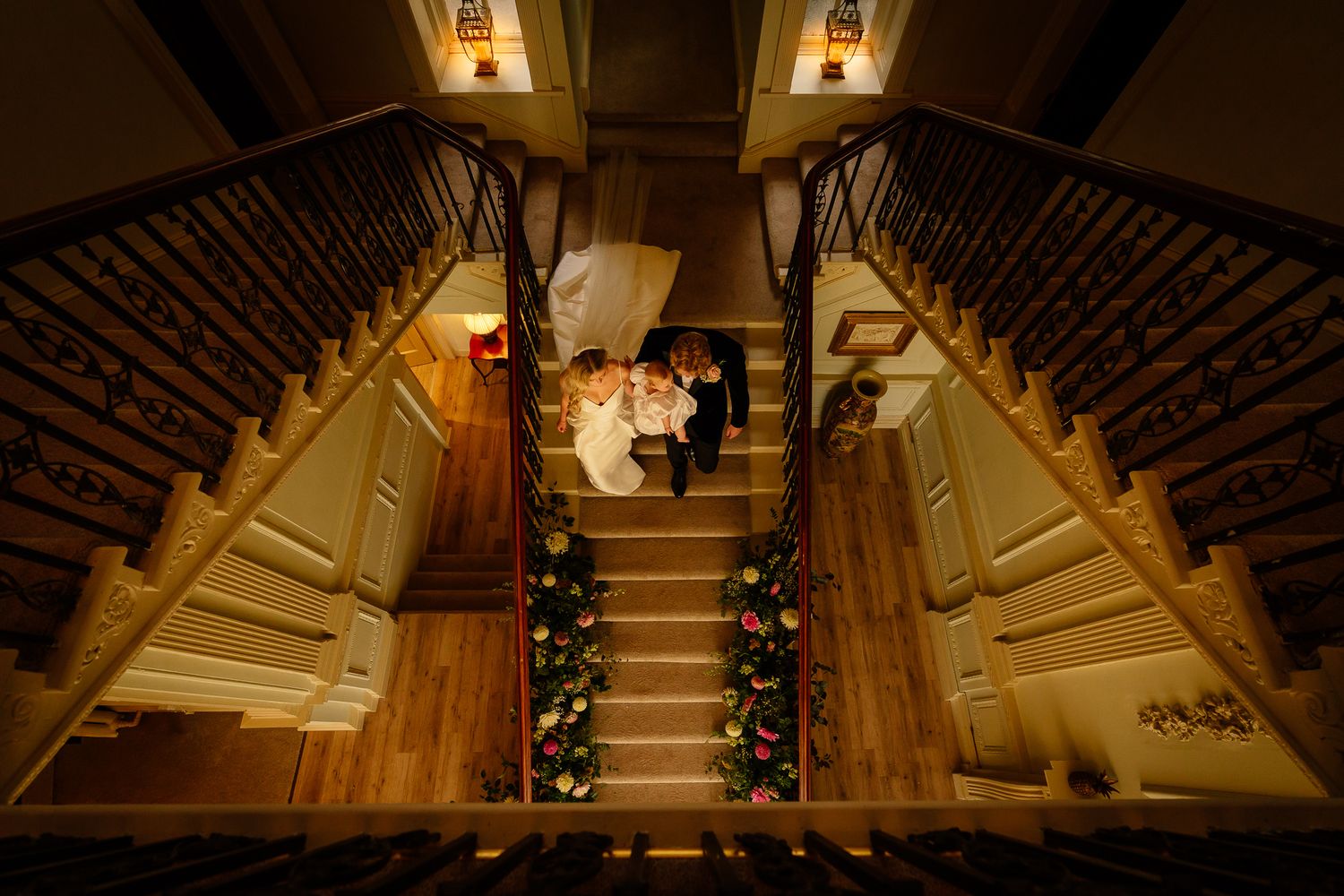 Artistic overhead view of a grand staircase decorated for a wedding celebration.
