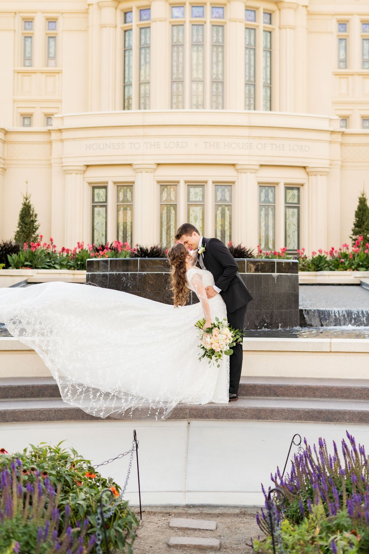 Wedding photography sequence with flowing veil at elegant building with fountains.
