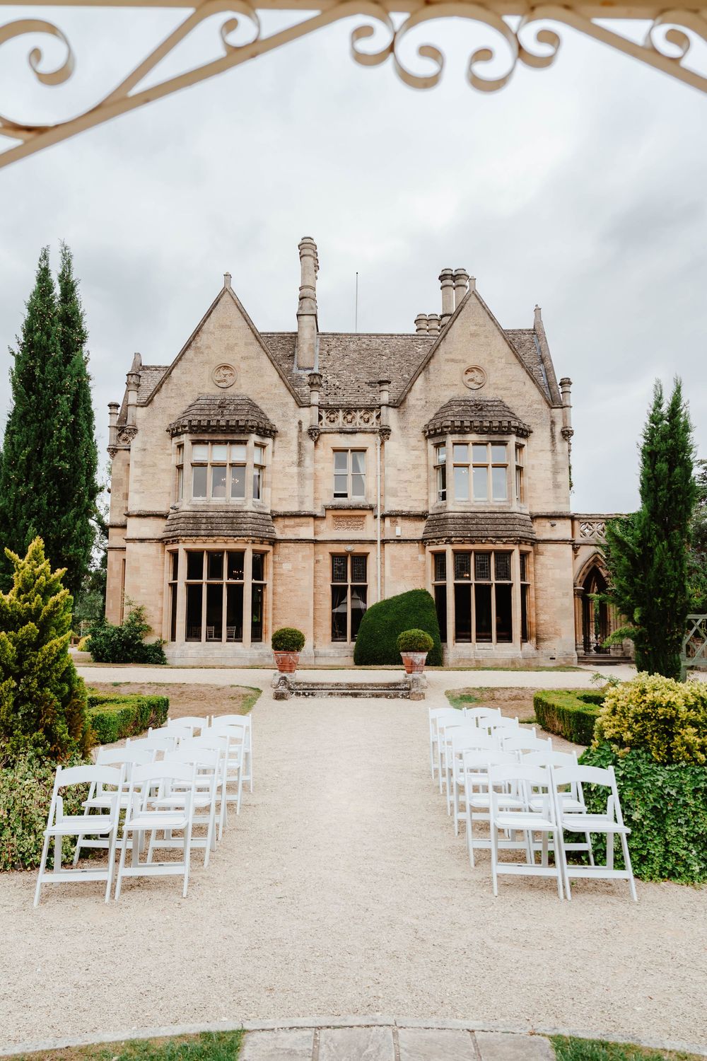 Wedding at Manor by the Lake Cheltenham Gloucestershire view of house from outdoor ceremony pergola