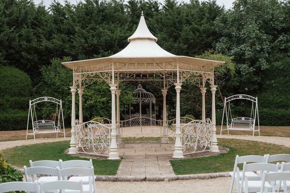 Wedding at Manor by the Lake Cheltenham Gloucestershire outside ceremony pergola garden
