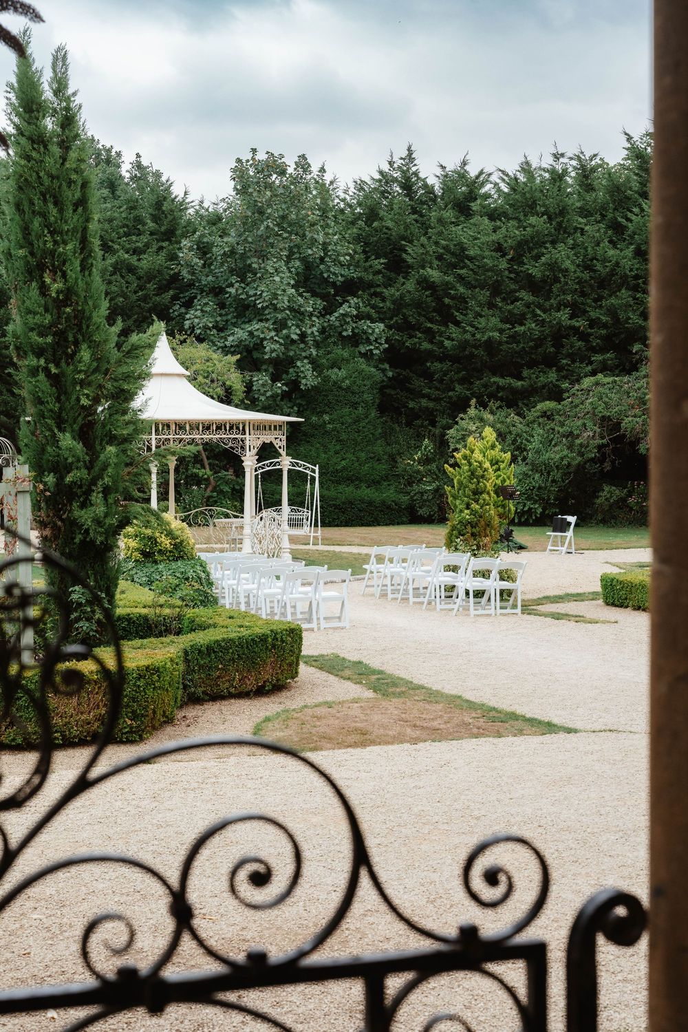 Wedding at Manor by the Lake Cheltenham Gloucestershire  outside ceremony space by gate