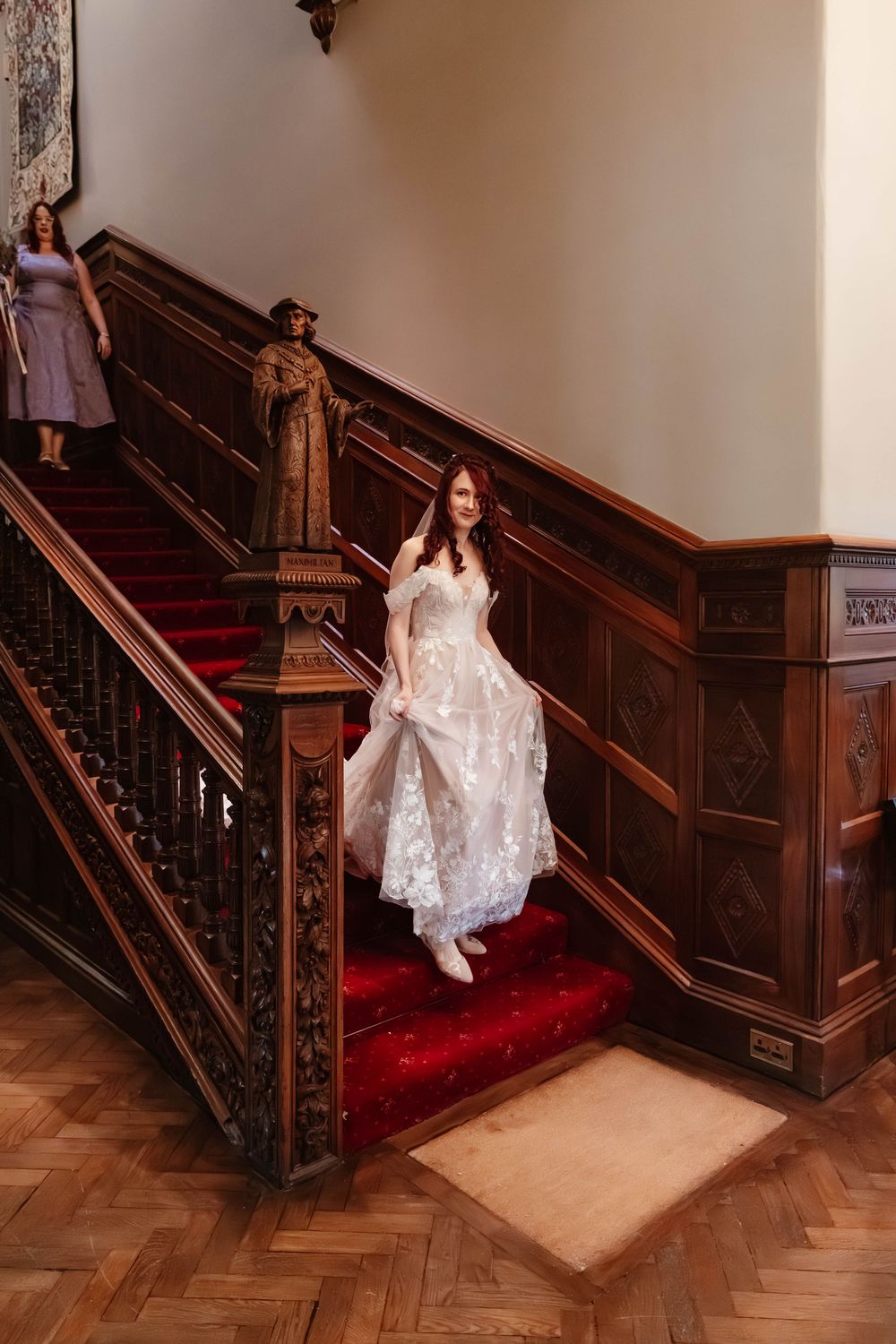 Wedding at Manor by the Lake Cheltenham Gloucestershire bride walking down staircase