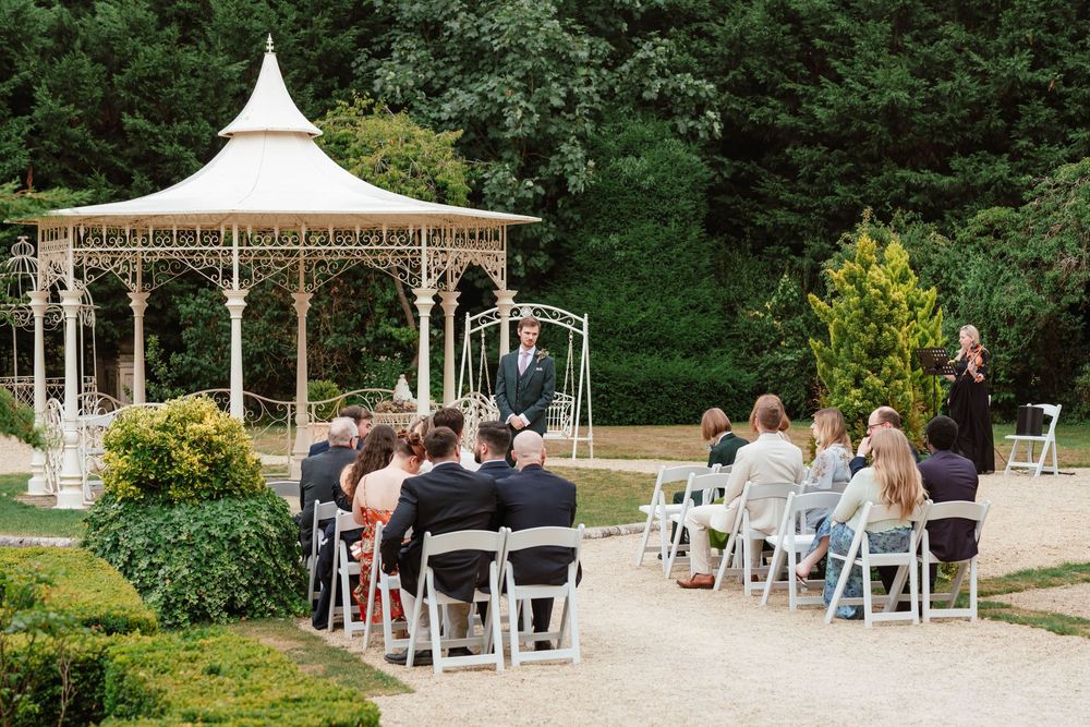 Wedding at Manor by the Lake Cheltenham Gloucestershire guests waiting outside ceremony