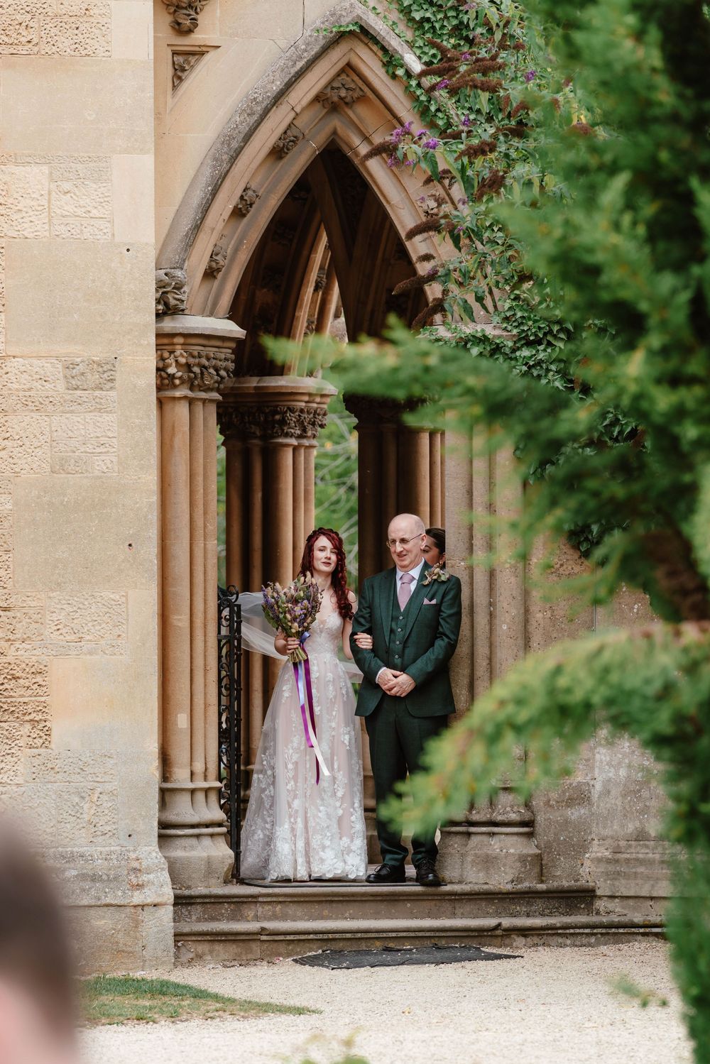 Wedding at Manor by the Lake Cheltenham Gloucestershire  bride and her dad outside waiting to walk down aisle
