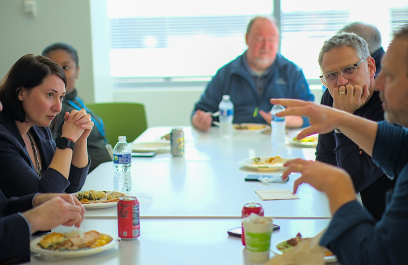 Corporate meeting photography of Advarra executives in discussion at Maryland headquarters.