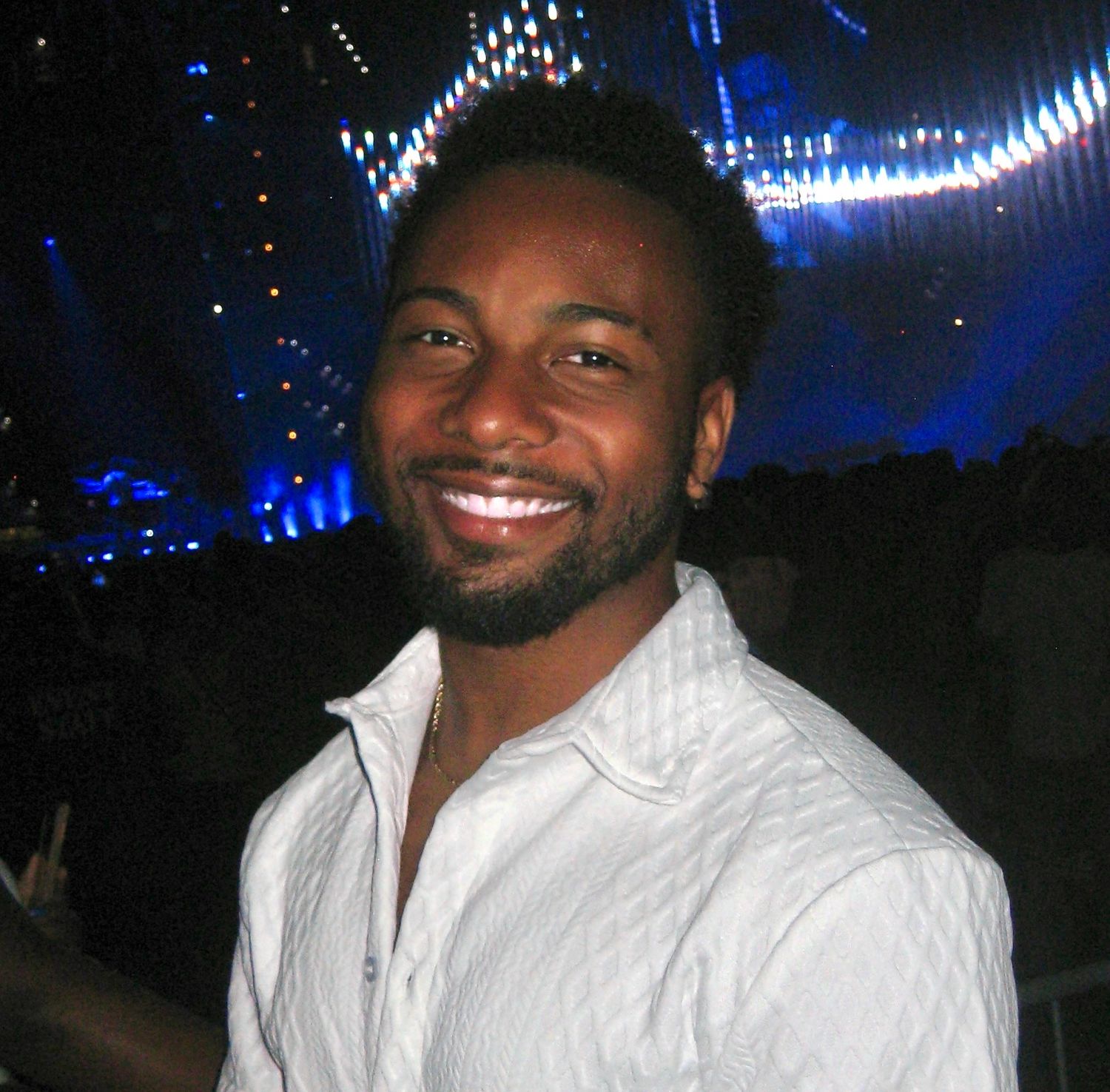 A nighttime portrait with blue stage lights in the background.