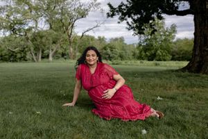A series of outdoor photos shows someone in a red dress relaxing on grassy lawn in a scenic park setting.