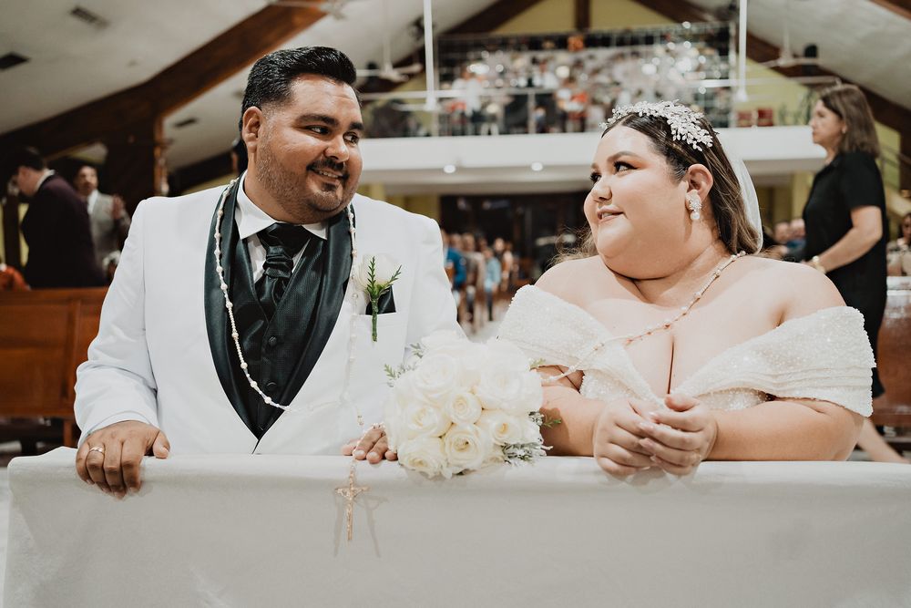 Candid black and white photo of wedding couple sharing a loving look and smile during their reception.