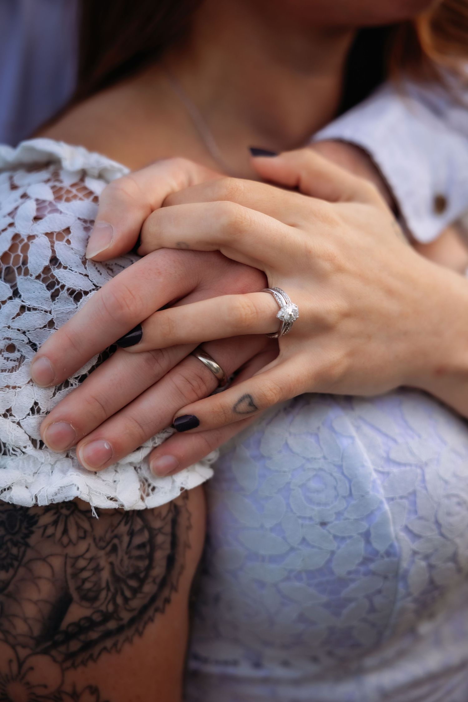 Close-up series of hands with wedding rings shown holding hands together against textured floral fabric background.