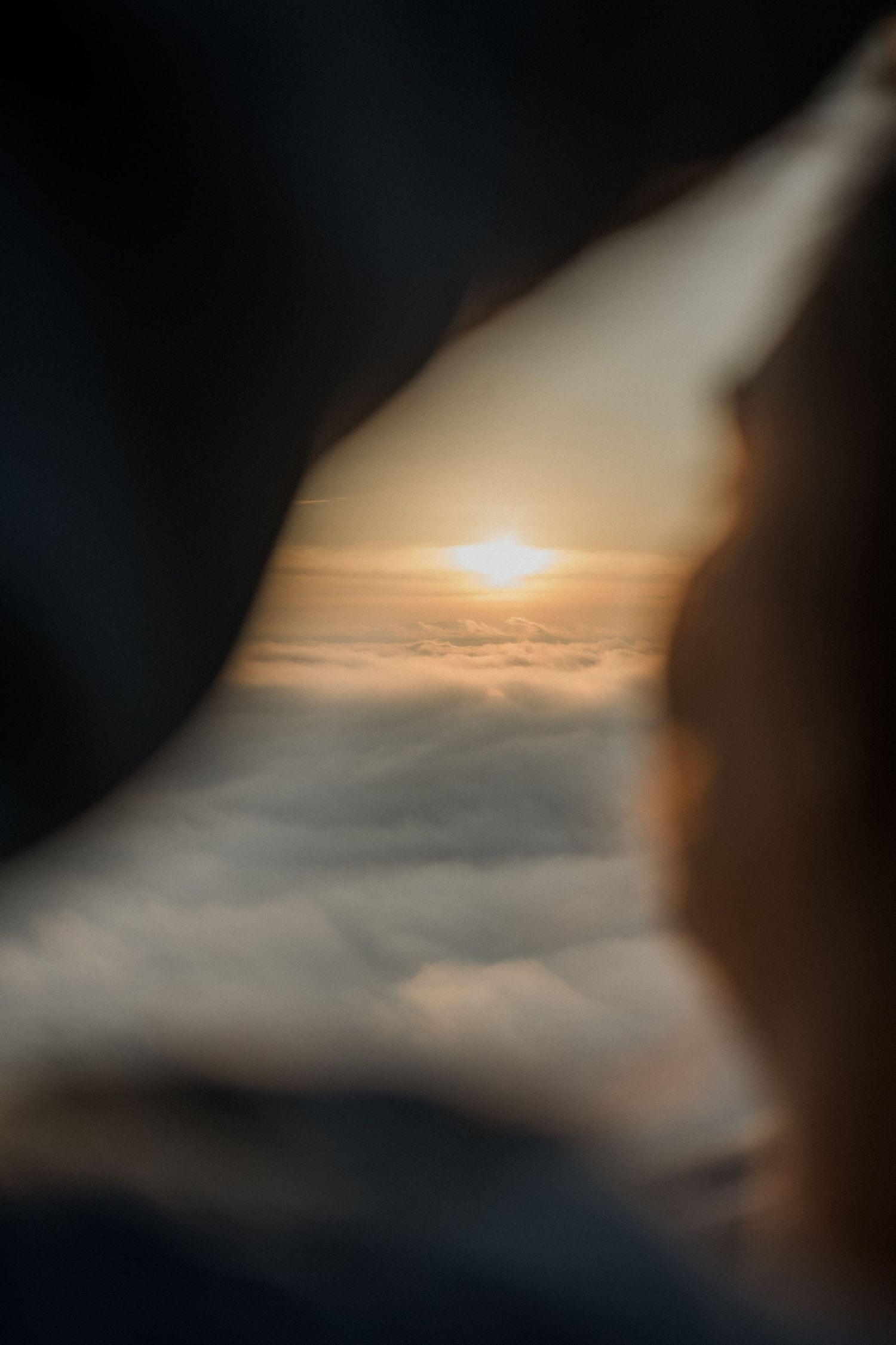 Aerial view of golden sunrise above fluffy clouds on a mountain in Mansfield, Victoria