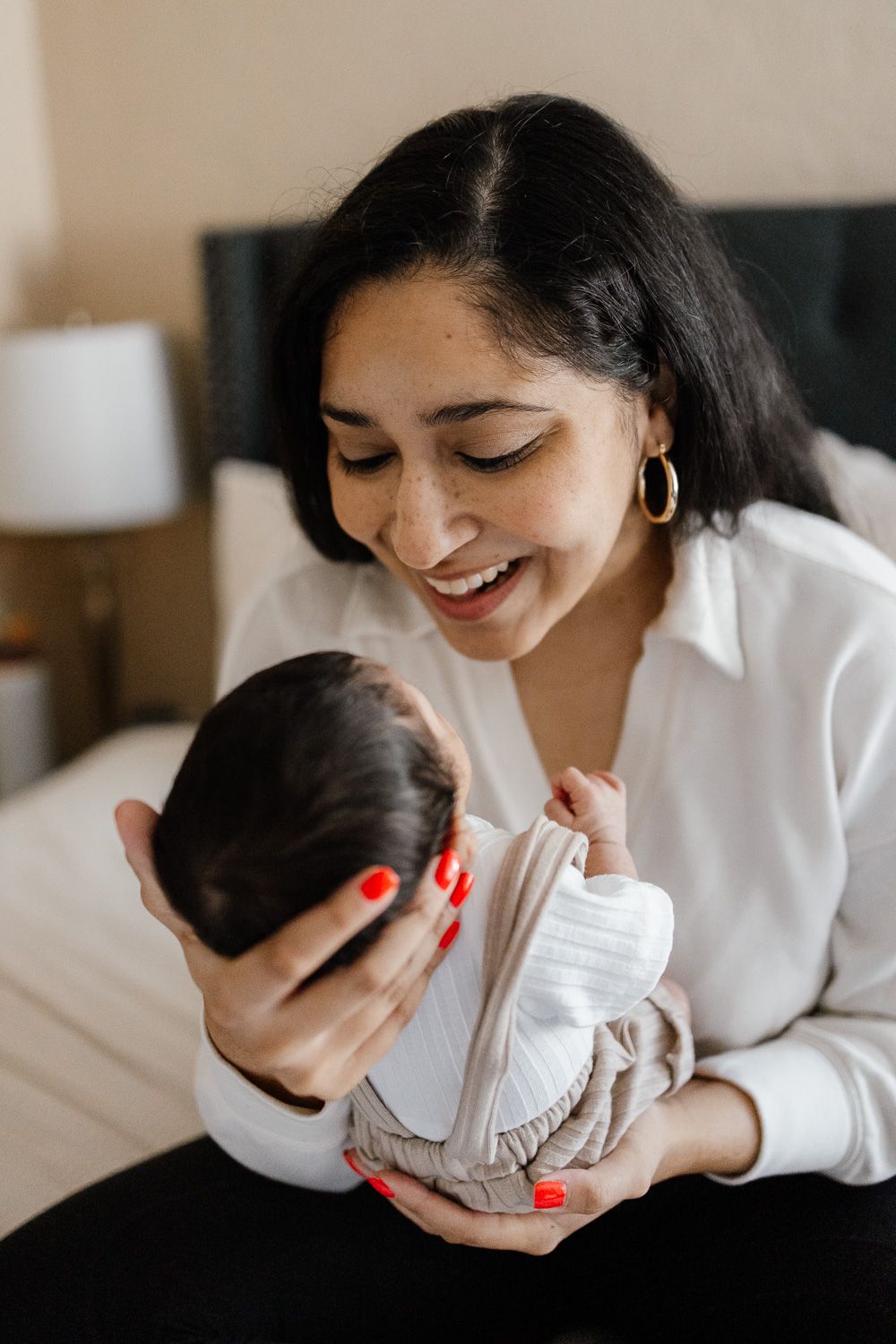 Bay Area newborn photography captures first family moments at home, including this mom cradling her sweet newborn baby boy