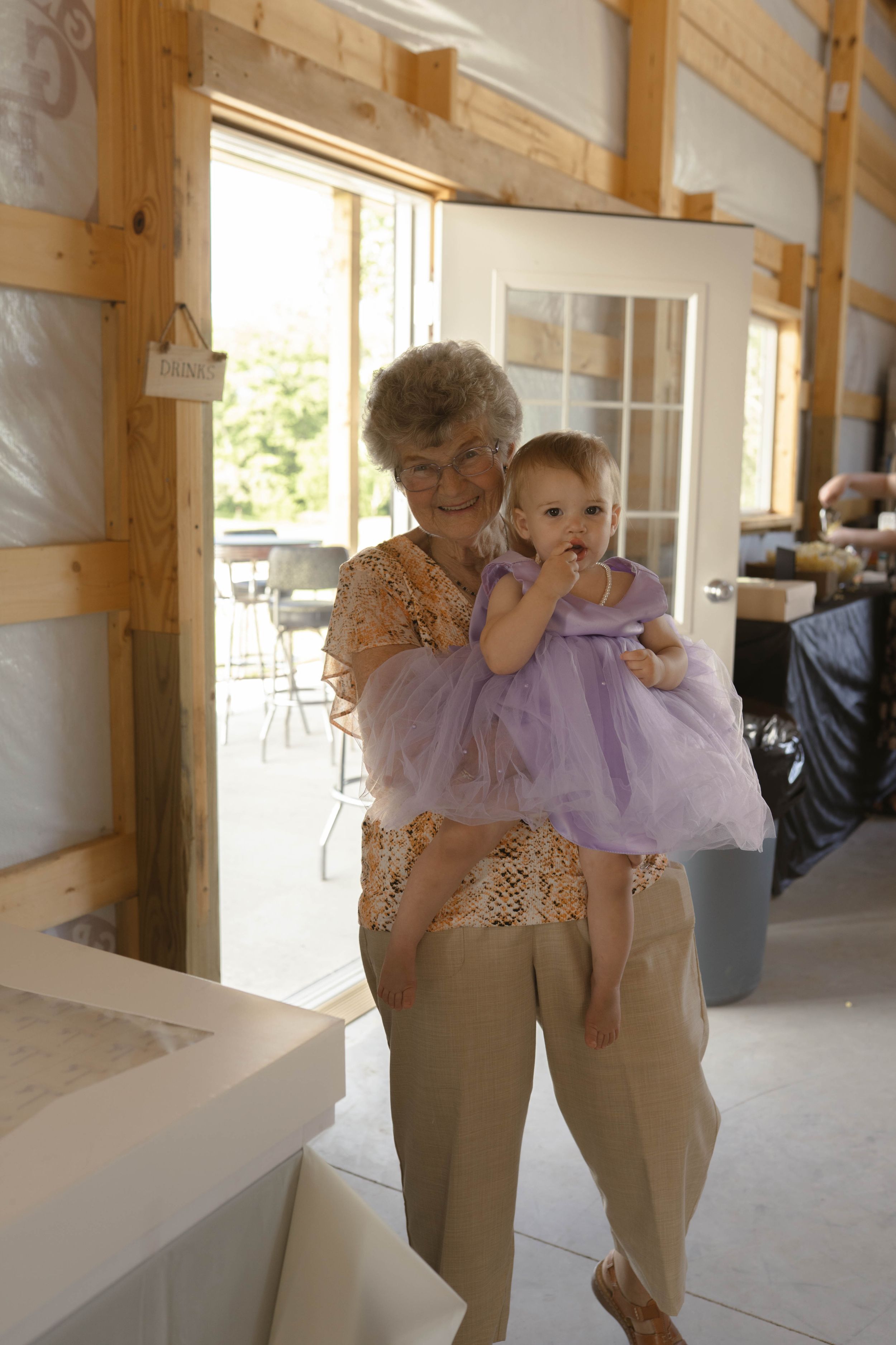 Sweet moment shared in a rustic barn venue with natural lighting.