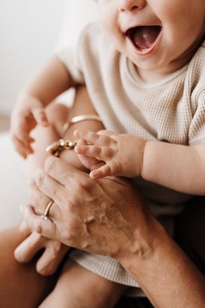 Close-up of tiny hands reaching and playing in warm natural light.