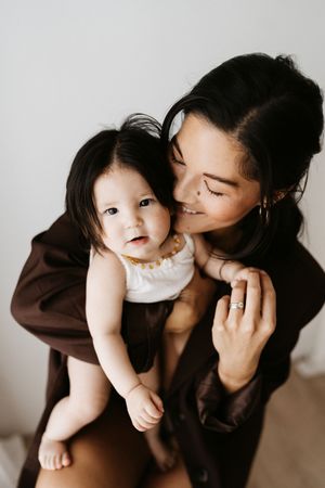 Intimate indoor portrait showing gentle embrace and genuine smiles.