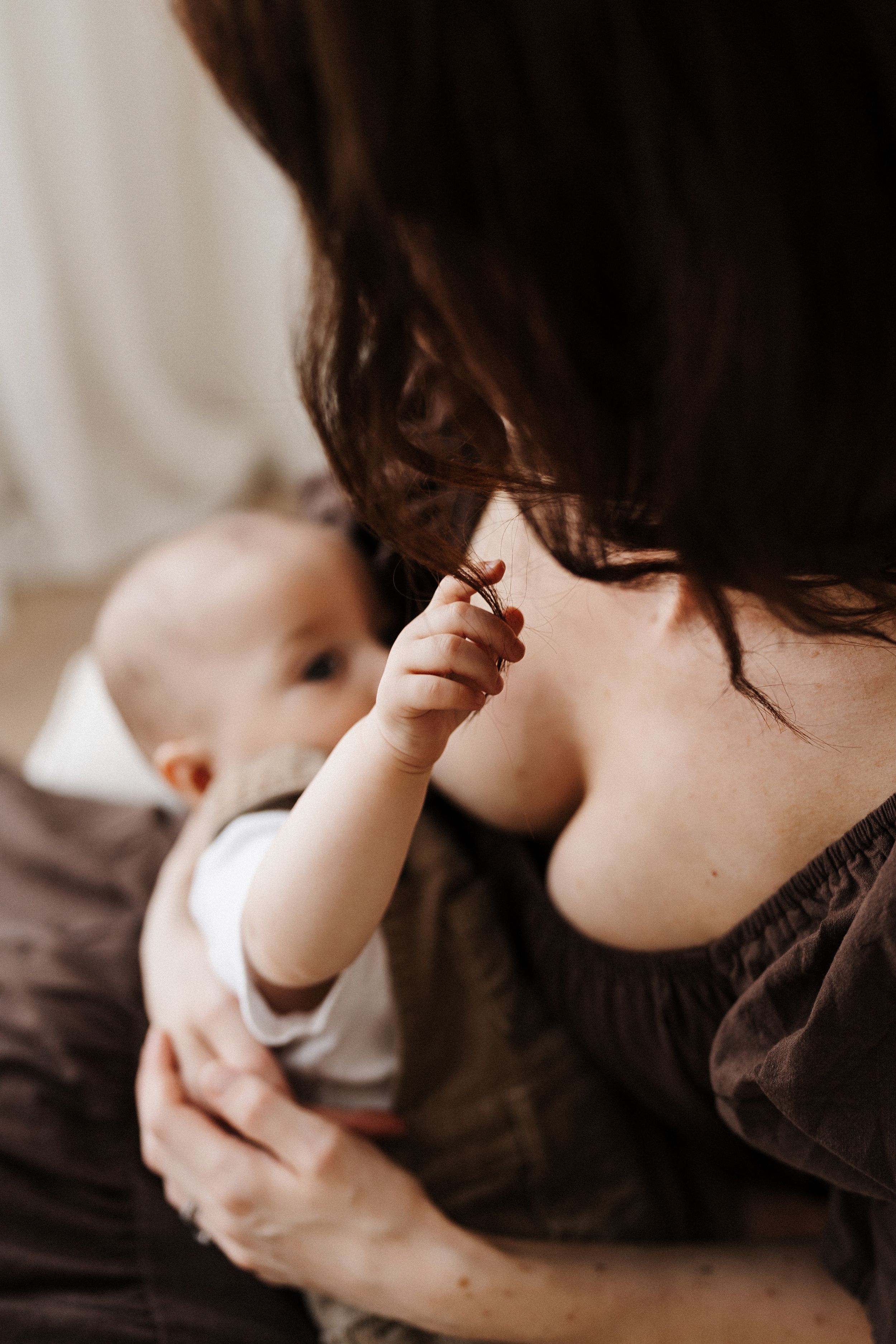 Intimate black and white close-up series showing gentle parenting moments.