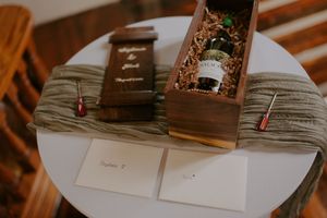 Elegant wooden books or albums displayed on a textured surface.