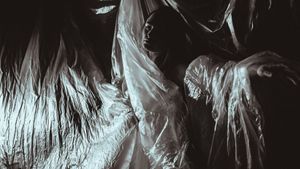 Abstract black and white pattern with flowing ethereal textures and wispy lines creating a ghostly atmospheric effect.