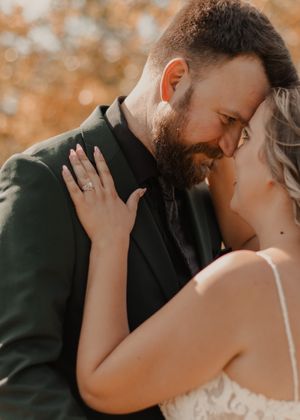 Close-up of bride and groom gazing lovingly into each other's eyes, capturing a romantic moment.