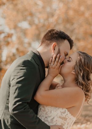 Close-up of bride and groom sharing a kiss, capturing a romantic moment.